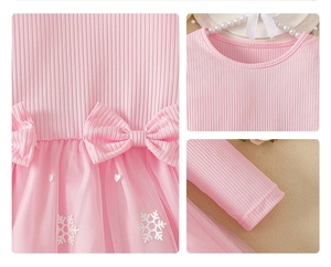 Detail of pink knit dress with bow waist and snowflake patterned mesh tutu skirt