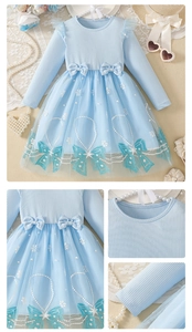 Detail of light blue girls' knit princess dress with snowflake mesh and cute bows