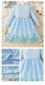 Detail of light blue girls' dress featuring knit texture and snowflake tulle mesh skirt