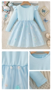 Détail de broderie flocon pailletée et couches de tulle sur robe à manches longues
