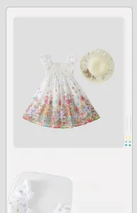 Detail of floral cotton summer dress for girls featuring ruffled straps and matching straw hat