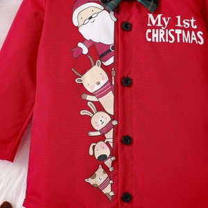 Detail of red Christmas baby romper with My 1st Christmas print and cartoon icons