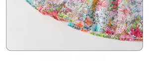 Close-up of lightweight floral summer dress hem with pink and orange flower patterns