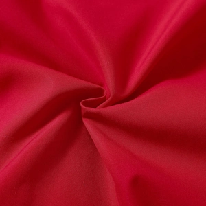 Detailed macro view of red twill fabric texture for Christmas infant romper clothing