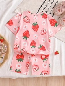 Pink girl's summer pajamas set with cute strawberry and daisy patterns on soft fabric