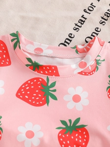 Pink cotton children's summer pajamas with strawberry print and round neckline detail