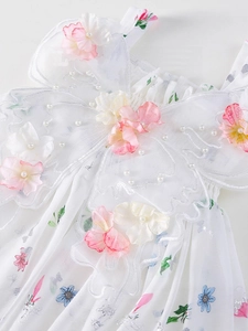 Floral sleeveless girls dress featuring 3D flowers, pearls, and ruffled neckline detail