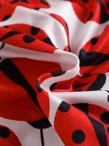 Detailed macro shot showing soft breathable cotton fabric with ladybug polka dot print