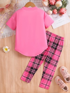 Flat lay of girl's pink short sleeve T-shirt and black pink plaid leggings set