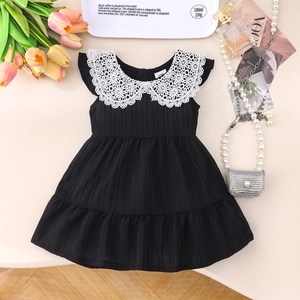 Detail of baby girl black dress with white lace Peter Pan collar and ribbed texture
