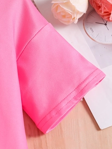Close-up of pink knit shirt sleeve showing high-quality double-needle stitching detail