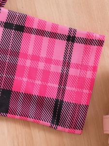 Close-up of pink and black plaid fabric showing high-quality double stitching detail