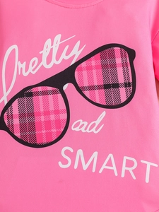 Detail of hot pink cotton T-shirt featuring Pretty and SMART print and dual stitching