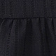 Close-up of black pleated fabric with vertical stripes and delicate hollow-out lace texture
