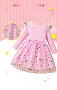 Detail of pink long sleeve tutu dress with colorful polka dots and mesh skirt