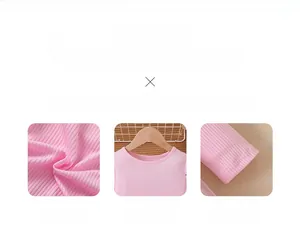 Close-up of pink ribbed fabric texture, round neckline and stitching detail for girls dress
