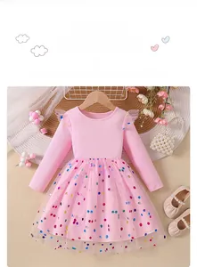 Detail of pink long-sleeve princess dress with layered tulle and colorful sequin dots