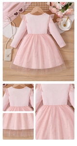 Close-up of pink tulle dress featuring gold star patterns and ruffled shoulder details