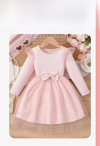 Detailed view of pink long sleeve tutu dress featuring gold stars and mesh flutter sleeves