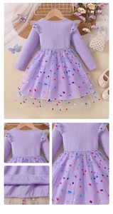 Detail view of purple tulle hem with colorful polka dots and fine knit neck stitching