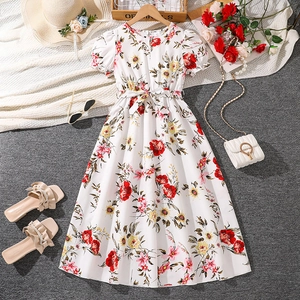 Detail of girls floral summer dress with puff sleeves, bow belt and red flower patterns