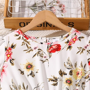 Detail of floral girls' dress neckline with size tag and vibrant flower pattern