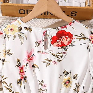 Detailed close-up of girls' floral dress with keyhole back and transparent button