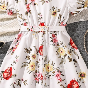 Detailed flat lay of floral girl dress with bubble sleeves and matching waist belt