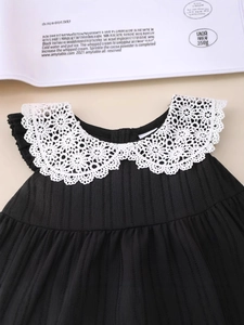 Girls black sleeveless dress with white lace collar and textured vertical stripes