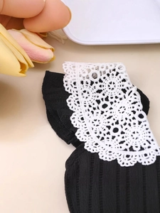 Girls' black pleated princess dress with intricate white lace collar and soft knit texture