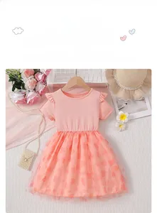 Detail of pink girls' tulle dress featuring flutter sleeves and heart pattern mesh skirt