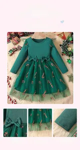 Detail of green Christmas tulle dress with red candy cane patterns and mesh embroidery