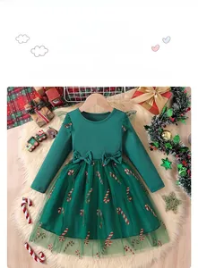 Detail of green long-sleeved dress with waist bows and festive candy cane tulle skirt