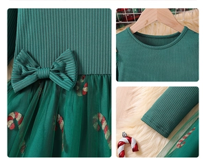 Detail view of the Christmas candy cane print on green mesh skirt and velvet bow ornament