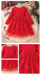 Detail of red Christmas dress with rib-knit fabric, mesh ruffles, and glitter patterns