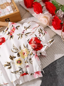 Girl's white short-sleeve floral dress with vibrant red and yellow blossoms