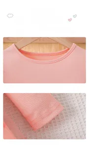 Detail of pink long sleeve knit dress showing ribbed neckline and elastic cuffs for girls