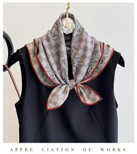 Detail of silk wool square scarf featuring grey check pattern and hand-rolled edges