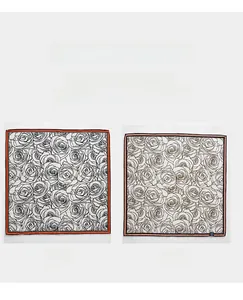 Detail view of double-sided rose print scarf with orange and pink contrast borders
