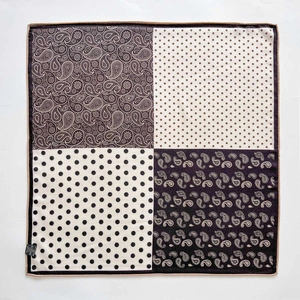 Detail of silk wool pocket square featuring paisley and polka dot patchwork patterns