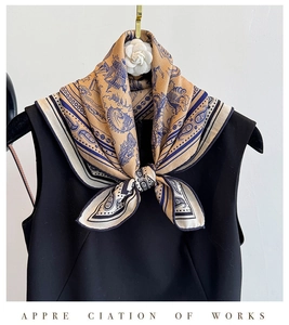Detail of silk wool square scarf with gold maritime prints on black dress for formal look