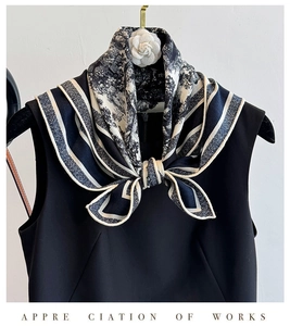 Detail of elegant black and white printed silk scarf with classic camellia flower ornament
