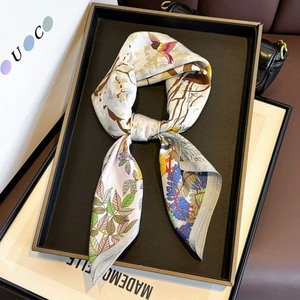 Elegant silk scarf featuring vibrant bird and floral patterns in light beige and blue colors
