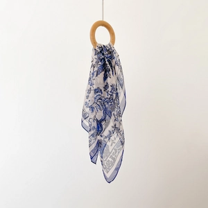 Detail of silk chiffon scarf with vintage blue floral prints and navy hemmed edges