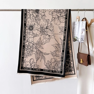 Macro detail of beige floral scarf with fringe edges and fashion flower border
