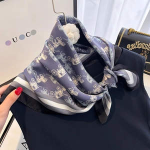 Elegant navy blue silk scarf with chariot totem print and white camellia brooch