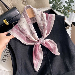 Floral butterfly print silk chiffon square scarf styled as an elegant neckerchief