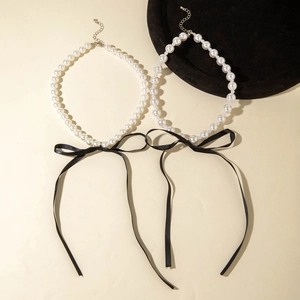 Elegant French style pearl necklace with a large black velvet ribbon bow and lobster clasp