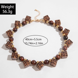 Detailed view of bohemian irregular necklace with brown beads and leopard print cubes