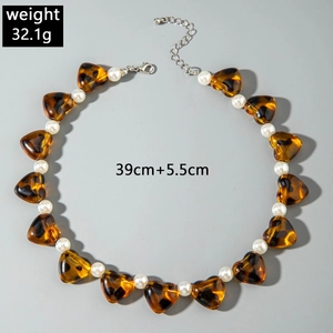 Detail of amber heart beads and white faux pearls on a 39cm necklace with 5.5cm chain